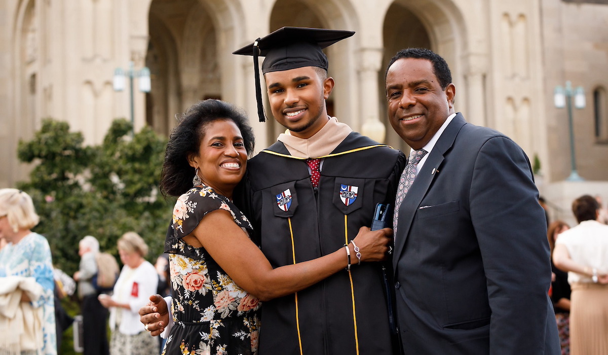 Parents with their graduate wearing his cap and gown